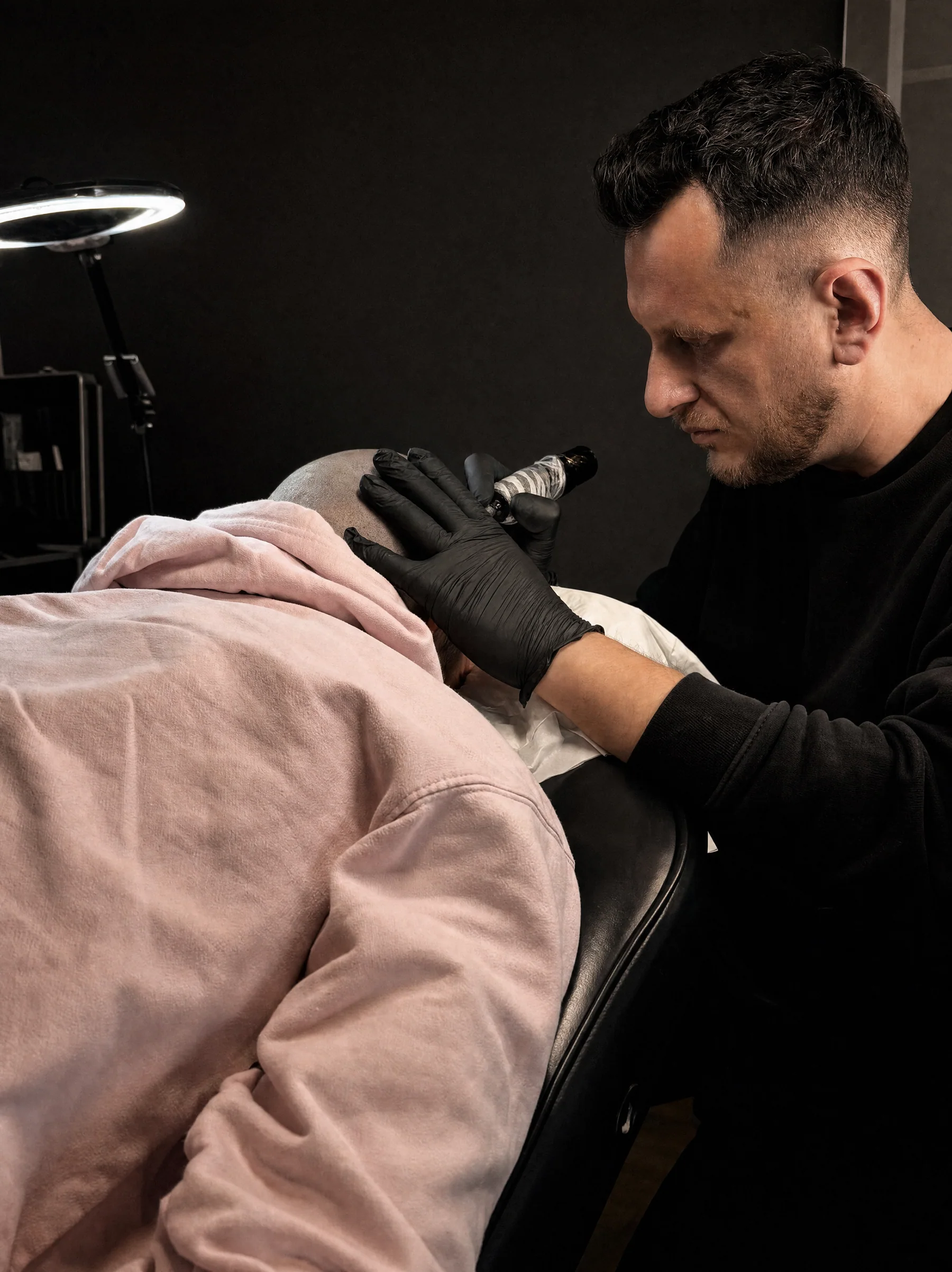 Vaggelis working during a private scalp micropigmentation session